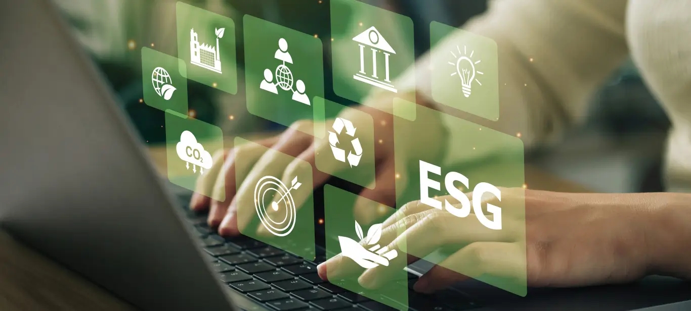 A person typing on a laptop with green icons, representing ESG software solutions.