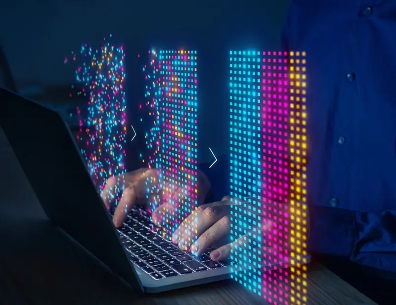 A person utilizing a laptop with vibrant LEDs, demonstrating AI data analytics and reporting